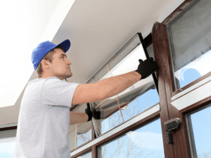 worker fitting impact window glass