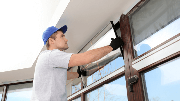 worker fitting window glass