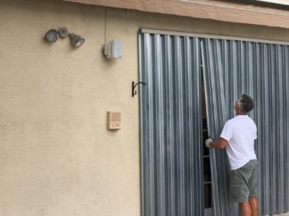 Worker inspecting hurricane shutters