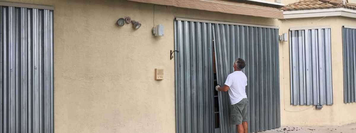 Worker inspecting hurricane shutters