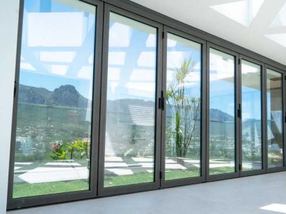 Impact glass doors installed in a house. Open skies in the background