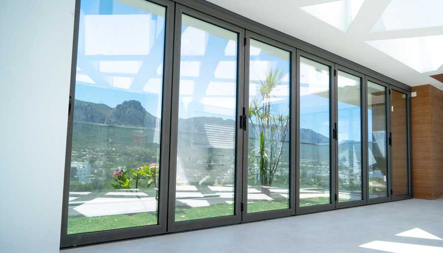 Impact glass doors installed in a house. Open skies in the background