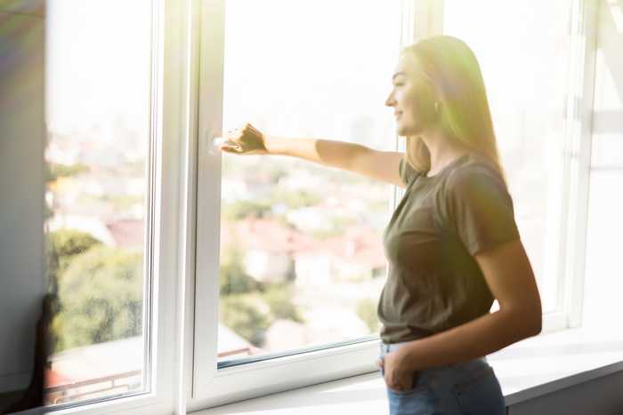 Women Opening Impact Resistant Windows