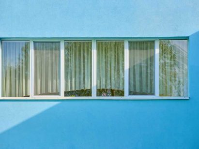impact windows on a blue painted house