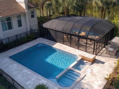 Professional Pool Cover Installation Over a Residential Swimming Pool with Landscaping and Screened Enclosure